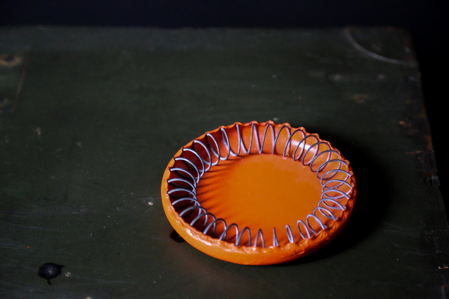 orange ashtray on black table top - interior designers austin texas