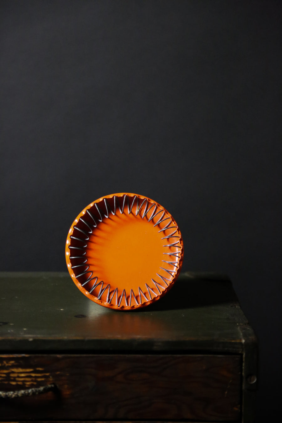 orange ashtray on dark wood chest - interior designers austin texas